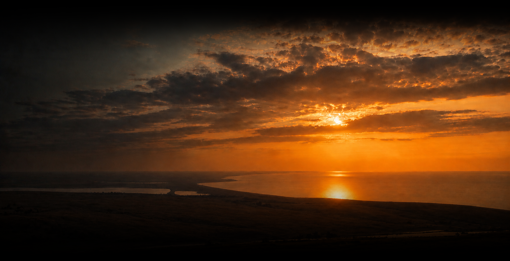 Wind turbines on a coastline at sunset